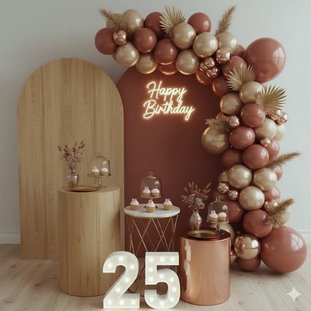 Terracotta and gold balloon arch with Happy Birthday neon sign